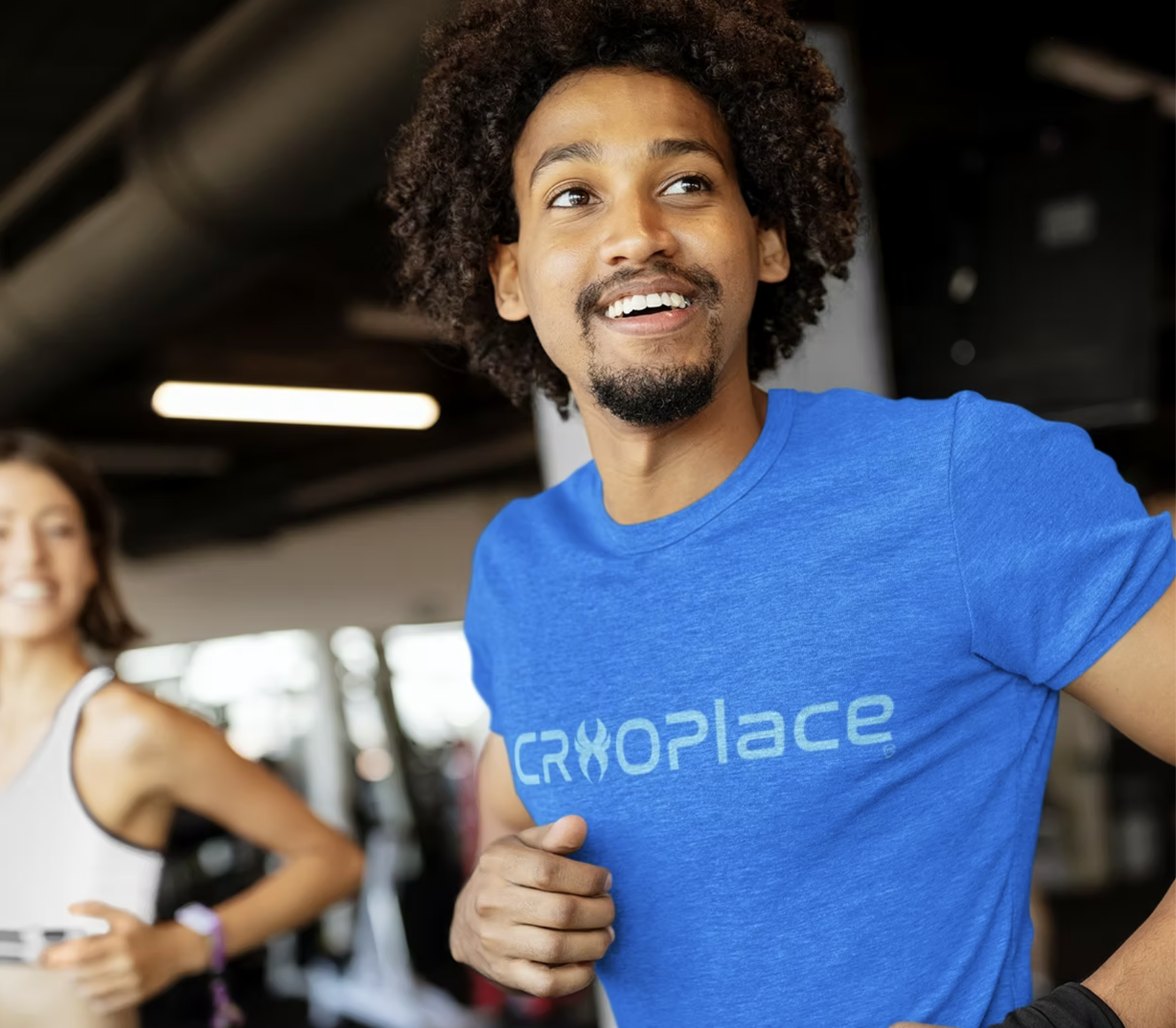 Two people training in a gym, one wearing a blue CryoPlace tee